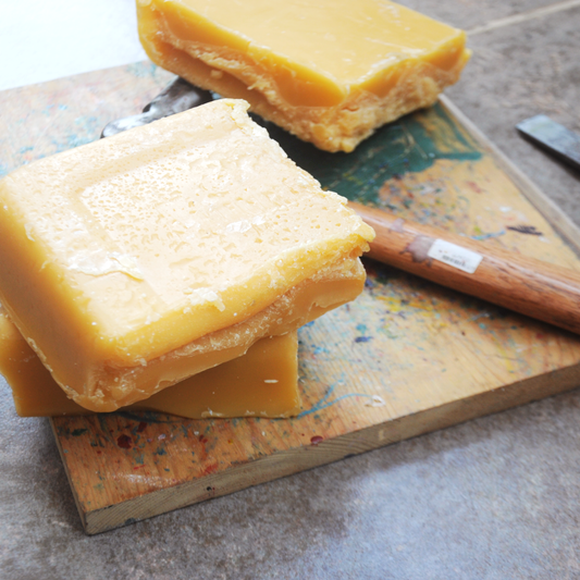 blocks of beeswax on a wooden board