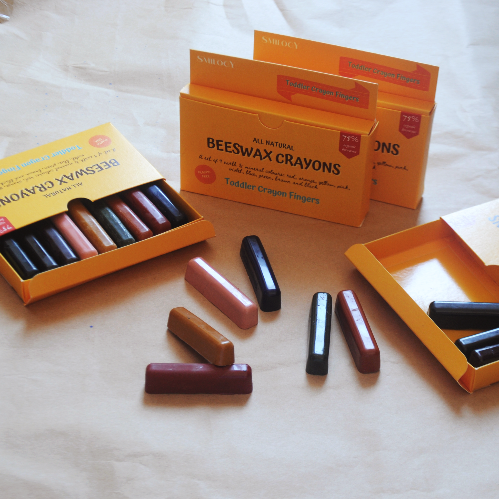 beeswax natural nontoxic finger crayons  for kids flat lay of crayons out of their case with sets of crayons nearby