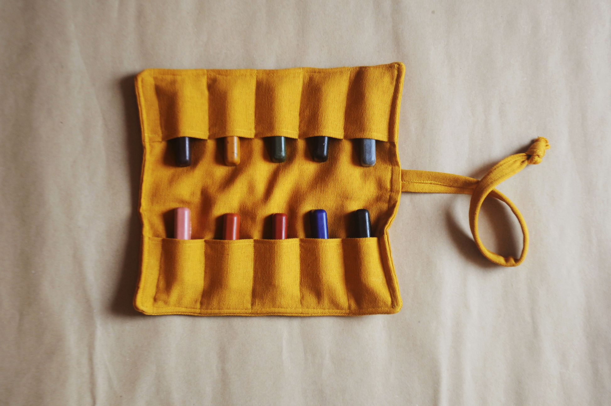 all natural beeswax crayons in a mustard crayon roll